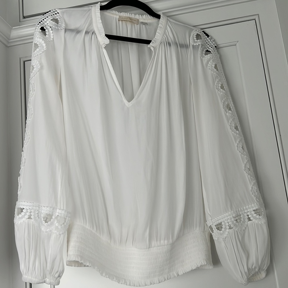 Can be worn open or closed to make a key hole. Lace cut out details on sleeve.